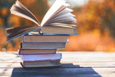 Books: Stack of books with top one opened